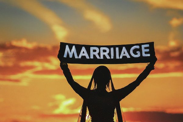 Girl holding marriage banner